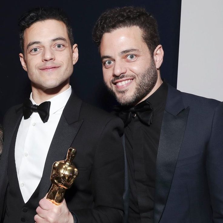 Sami and Rami Malek walking in a suit